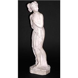 CARVED MARBLE FIGURE OF A BATHER, Italian. Circa 1900. The nude female with one foot on a rock...