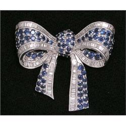 FINE DIAMOND AND SAPPHIRE "BOW" BROOCH, Set with approximately one hundred, twenty-two baguette...