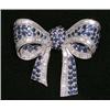 Image 1 : FINE DIAMOND AND SAPPHIRE "BOW" BROOCH, Set with approximately one hundred, twenty-two baguette...