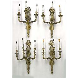 SET OF FOUR LOUIS XV STYLE GILT BRONZE THREE LIGHT SCONCES, Each leaf and ribbon backplate supp...