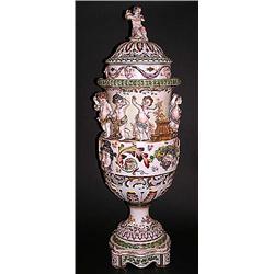 LARGE CAPO DI MONTE PORCELAIN URN AND COVER, Italian. Molded with masks and putti in high relie...