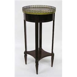 EMPIRE STYLE MAHOGANY SIDE TABLE, Circa 1900. The circular marble top enclosed by a brass galle...