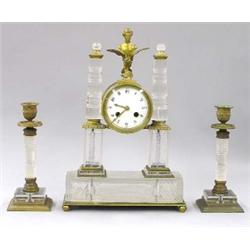 THREE PIECE NAPOLEON GILT BRONZE AND CUT GLASS CLOCK GARNITURE, French. 19th Century. The circu...
