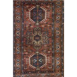 Qashqai Rug, Post 1950, Red ground with a rosette field enclosing three shaped medallions on...