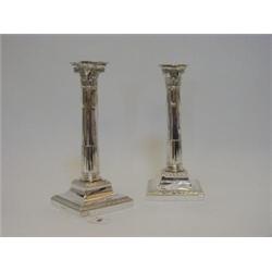 A PAIR OF EDWARDIAN PLATED CANDLESTICKS, corinthian columns, detachable bobeches, square weighted...
