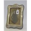 Image 1 : A SILVER EASEL PHOTOGRAPH FRAME, bow and ribbon border, machine engraving, rectangular opening 13...