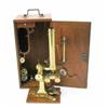 Image 1 : A late 19th century brass monocular microscope in mahogany case, with additional lenses and side...
