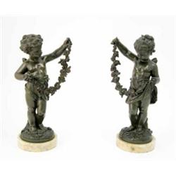 A pair of French late 19th century bronze cherubs by one of the Moreau family, each winged figure...