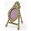 Image 1 : A late 19th century gilt metal and enamel miniature frame, in the form of an oval frame on an eas...