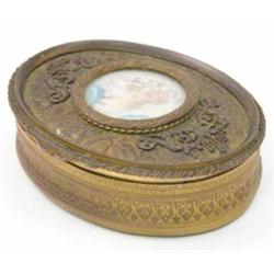 A French early 20th century gilt metal oval box, the cover set with a portrait miniature of a gir...