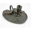 Image 1 : An Art Nouveau bronze chamberstick, cast as a lily pad with lily leaf nozzle upon which a female...