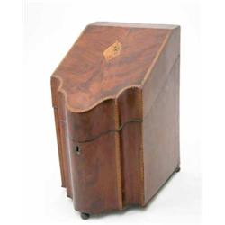 A George III mahogany knife box, the sloping cover inlaid with a shell paterae, the edges with ch...