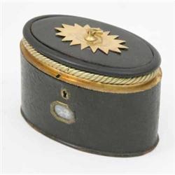 A late 18th century brass mounted oval caddy or jewellery casket, with black lacquered body appli...