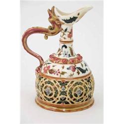 A Zsolnay Pecs double-walled earthenware ewer, painted with foliage and pierced with scrolls, pri...