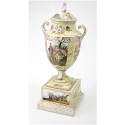 A late 19th century Crown Dresden two-handled vase and cover, on plinth, painted with figure pane...