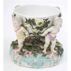 A 19th century Sitzendorf centrepiece, modelled with four nymphs supporting floral-encrusted bowl...