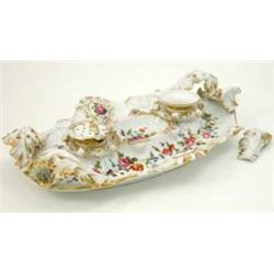 A Jacob Petit inkstand, of rococo shape painted with flowers and fitted with inkwell and pounce p...