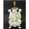 Image 1 : A large white-glazed earthenware table lamp, modelled with four children with interlocked arms, o...