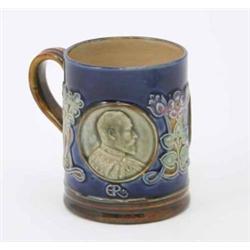 A Doulton Lambeth Royal commemorative stoneware mug, decorated with roundels of Edward VII and Qu...