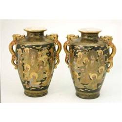 A pair of Satsuma high shouldered vases, with dragon handles, decorated with immortals on a black...