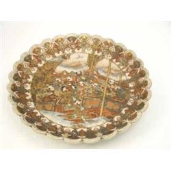 A late Satsuma dish, with petaled rim, decorated with a panel of figures on a terrace, 15.5ins...