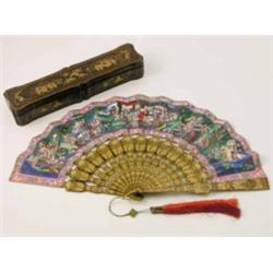 A late 19th century Japanese fan, with papier mache sticks gilded with chinoiseries against a bla...