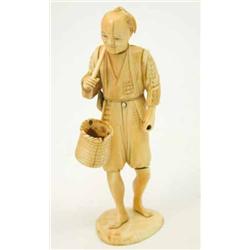 A Japanese ivory okimono, of a fisherman with a basket and a tool on his back, parts lacking, ins...