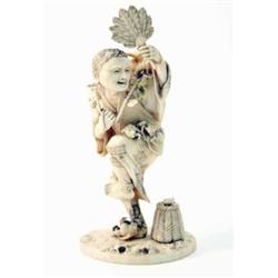 A Japanese Meiji ivory okimono of a frog man, the figure balance on one foot holding a fan, frogs...