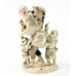 A Japanese Meiji ivory okimono, of a man with two children, a child alarming a cockerel by holdin...