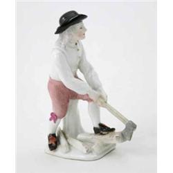 A Meissen figure of a Woodcutter by J.J. Kaendler, wearing a black hat, loose white shirt and jer...