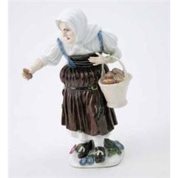 A Meissen figure of an old peasant woman modelled by J.J. Kaendler, standing, wearing a white sha...