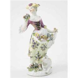 A Meissen figure of a Shepherdess with an apron of flowers, pink bodice, yellow hat and dress wit...