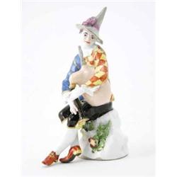 A Meissen figure of Harlequin playing the bagpipes modelled by J.J. Kaendler in conical hat with...