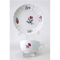 A Meissen teacup and saucer painted with flower-sprays within a Dulong-pattern border, the cup wi...