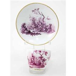 A Meissen cup and a saucer painted after Rugendas with a battle scene and martial trophies with g...