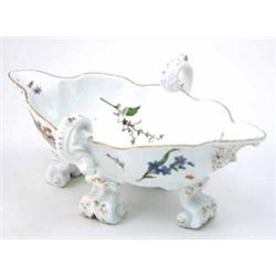 A Meissen two-handled double lipped sauceboat on four scroll feet, painted with flower-sprays and...