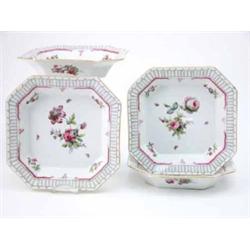 Four Berlin octagonal dishes painted with bouquets of flowers and insects within a border of scro...