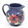 Image 1 : A Moorcroft Pansy Jug, circa 1930, decorated with an encircling pattern in shades of pink, purple...