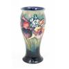 Image 1 : A Moorcroft frilled orchids baluster vase, with flared rim, circa 1940, decorated with an encircl...