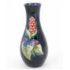 Image 1 : A Walter Moorcroft Arum lily swollen bottle vase, circa 1960, decorated in shades of red, purple,...