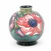 Image 1 : A Moorcroft Anemone posy vase, circa 1949, decorated in shades of pink, blue and green against a...