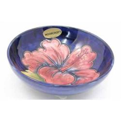 A Moorcroft Hibiscus bowl, circa 1975, decorated in pink and green against a blue ground, impress...