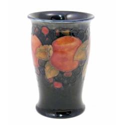 A Moorcroft Pomegranate vase, with everted rim, circa.1920, decorated in shades of orange, pink,...