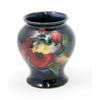 Image 1 : A Moorcroft Orchid posy vase, circa 1960, decorated in shades of red, yellow and green against a...