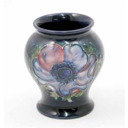 A Moorcroft Anemone posy vase, circa 1960, decorated in shades of blue, pink and green against a...