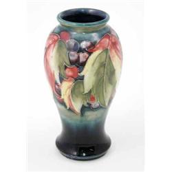 A Moorcroft leaf and berry vase, circa 1928-1949, decorated in shades of red, blue, yellow and gr...