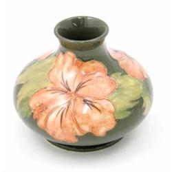 A Moorcroft coral Hibiscus squat vase, circa 1968-1980, decorated in shades of green and coral ag...