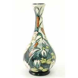 A Moorcroft Lamia vase, circa 2001, decorated in shades of green, brown and white against a cream...