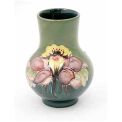 A Moorcroft Columbine posy vase, post war, decorated in shades of green, pink and yellow against...