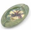 Image 1 : A Moorcroft Hibiscus oval ashtray, post war, decorated with a single flowerhead against a green g...